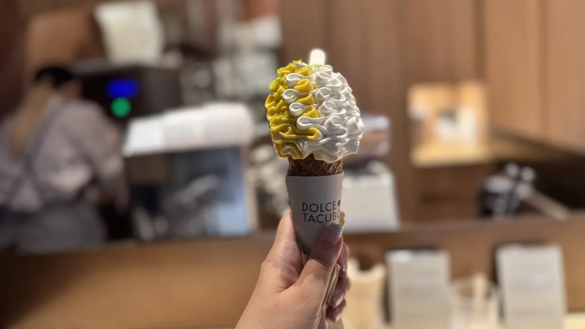DOLCE TACUBO Caffeのソフトクリームのアップ。背景をぼかした店内